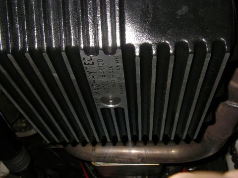 1990 Ford Bronco - Underside view of a MAG-HYTEC transmission pan, identified by its model number and manufacturing origin.