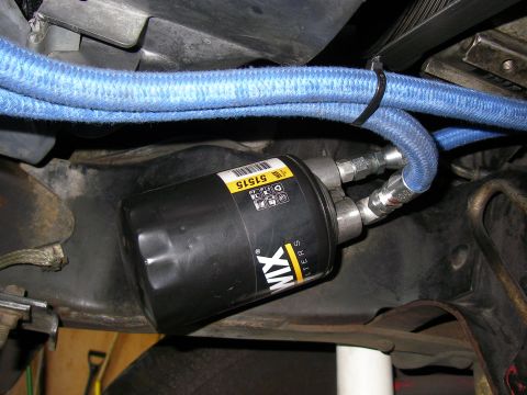 1990 Ford Bronco - A Wix oil filter is visible with a blue braided hose connected to it.