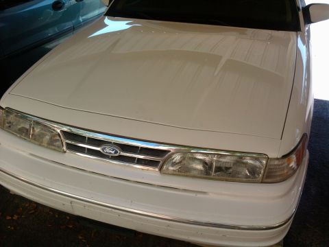 1997 Ford Crown Victoria - Front view of a white 1997 Ford Crown Victoria showing the grille and headlights.