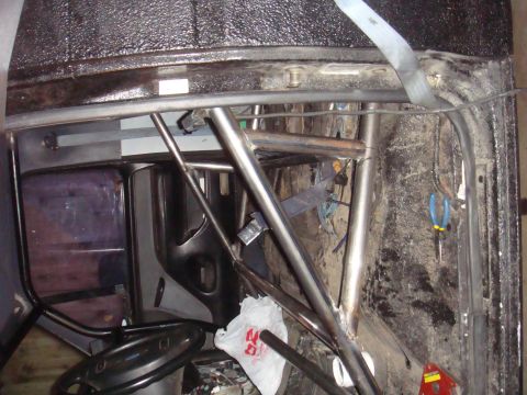 1992 Ford Bronco - A close-up view of a vehicle's interior, focusing on the installed roll cage structure.