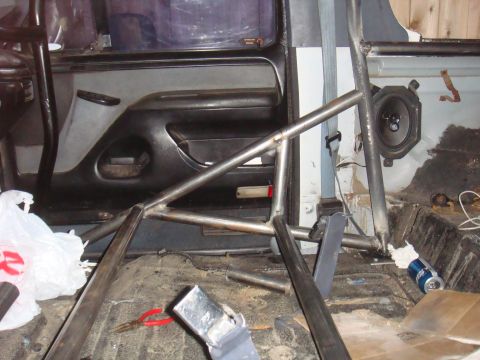1992 Ford Bronco - Custom roll cage installed inside a vehicle's interior, obscuring most of the original components.