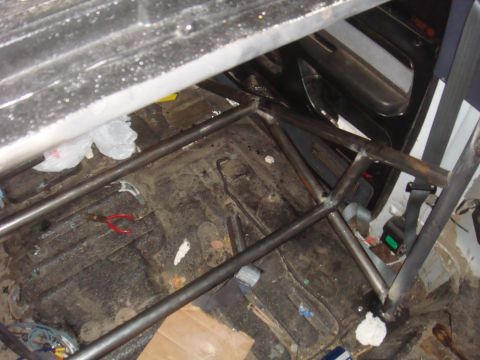 1992 Ford Bronco - A custom roll cage is installed inside a vehicle, obscuring most of the interior details.