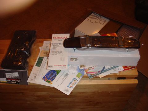 1992 Ford Bronco - Automotive rearview mirror and other items are piled on a wooden surface.
