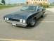 1969 Ford Torino - A dark blue sedan from the 1970s is parked on asphalt. The vehicle's front end is visible from a three-quarter perspective.