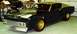 1969 Ford Torino - A black 1969 Ford Torino is shown from the front quarter angle with gold wheels.