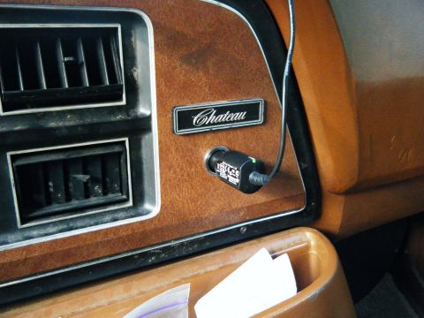 1981 Ford E350 - Close-up of a vehicle's dashboard showing the Chateau trim level and an accessory power adapter.