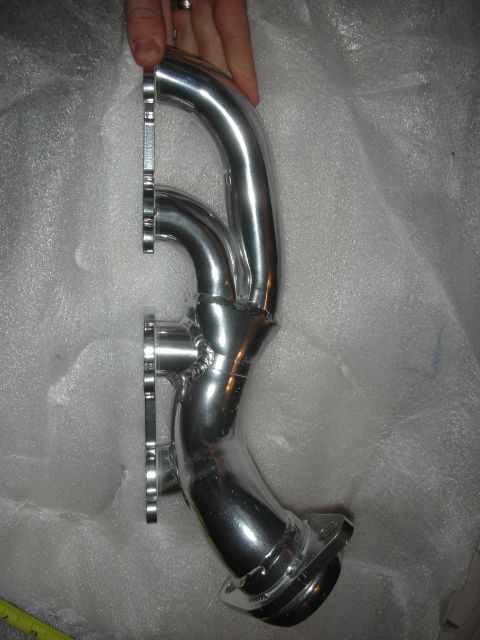 1998 Ford Crown Victoria - Polished exhaust manifold, likely for an aftermarket performance upgrade.