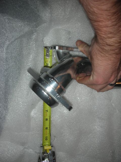 1998 Ford Crown Victoria - A chrome exhaust pipe is being measured with a tape measure.