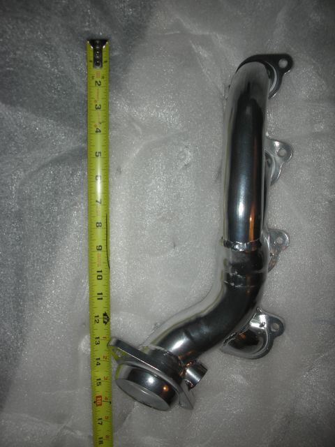 1998 Ford Crown Victoria - A chrome exhaust pipe is measured with a tape measure, indicating its dimensions.