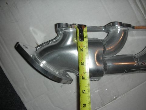 1998 Ford Crown Victoria - A close-up view shows an exhaust manifold with a tape measure indicating its dimensions.