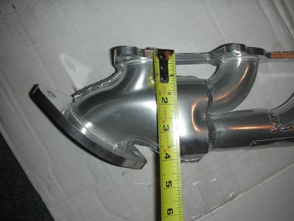 Exhaust manifold being measured with a tape measure