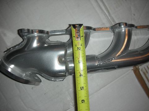 1998 Ford Crown Victoria - Aluminum exhaust manifold being measured with a tape measure.