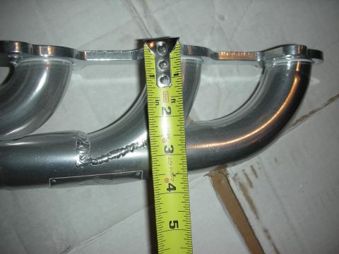 1998 Ford Crown Victoria - A tape measure is used to show the dimensions of a custom exhaust manifold.