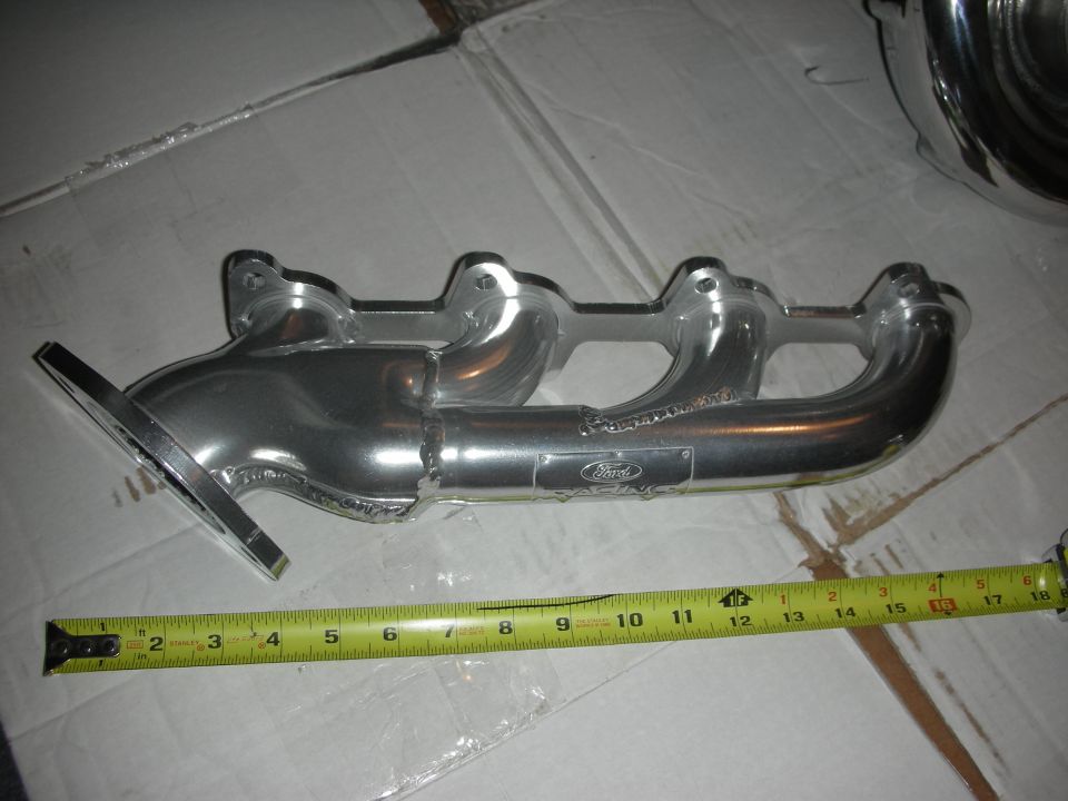 Aluminum exhaust manifold with Ford logo and measurement tape