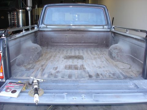 1979 Ford F-250 - A rear view of a truck bed, showing sanding equipment and discs, indicating preparation for work.