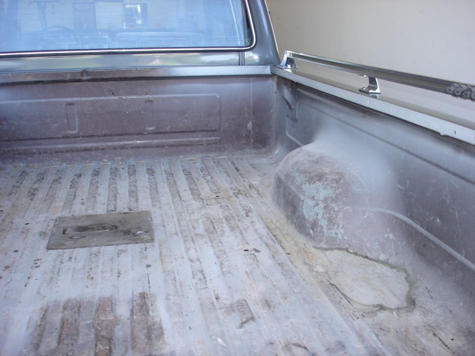 Truck bed interior with bedliner and chrome rail