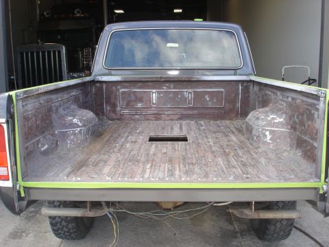 1979 Ford F-250 - The bed of a 1979 Ford F-250 pickup truck is shown, with exposed metal and wooden planks, ready for restoration.