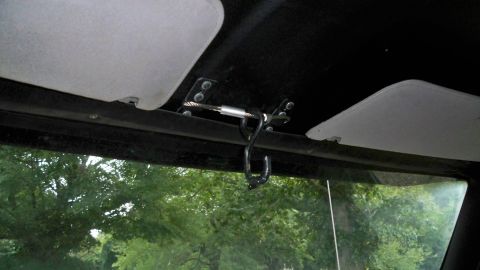 1994 Ford Bronco - Interior view of a vehicle's headliner with sun visors and an aftermarket hook.