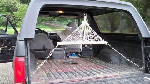 1994 Ford Bronco - The interior of a 1992 Ford Bronco is shown with two hammocks installed for relaxation.