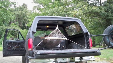 1994 Ford Bronco - Ford Bronco's rear interior configured with a hammock for relaxation.