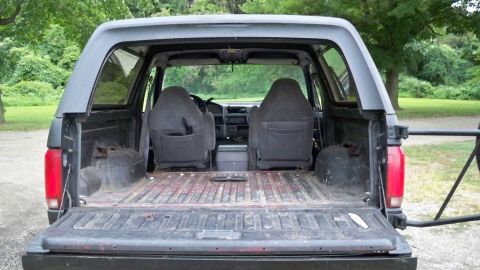1994 Ford Bronco - Interior and cargo area of a Ford Bronco, viewed from the rear with the tailgate open.