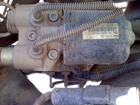 1996 Ford Bronco - Close-up of a dusty ABS control module with a Ford part number visible on a label.