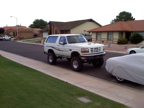 1996 Ford Bronco - This lifted 1996 Ford Bronco features custom side graphics and sits parked on a suburban street.