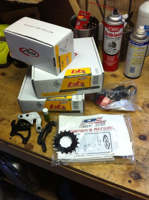 2010 Hyundai Genesis - Bicycle components and cleaning supplies are organized on a workbench.