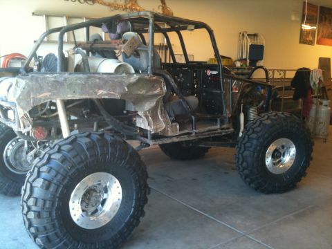 1966 Ford Bronco - Custom buggy with large tires and roll cage, possibly under construction.