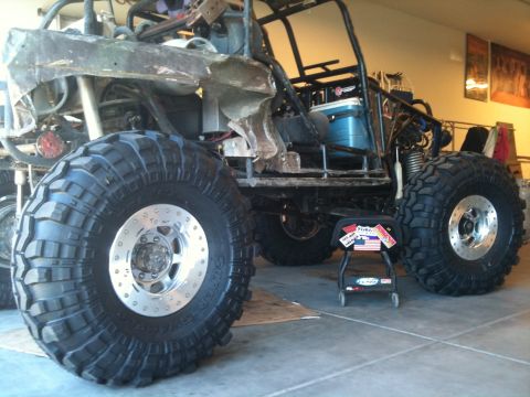 1966 Ford Bronco - This heavily modified off-road buggy features oversized mud-terrain tires and a custom roll cage, suggesting it's built for extreme terrain.