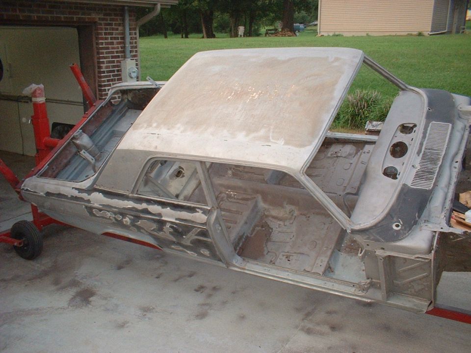 1964 Ford Fairlane body on restoration stands, stripped and prepped for paint