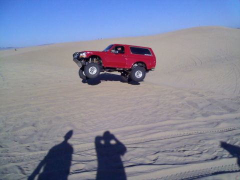 1994 Ford Bronco - This modified 1994 Ford Bronco is captured mid-air while traversing sand dunes.