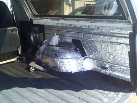 1994 Ford Bronco - Sound deadening material is being installed in the cargo area of the vehicle.