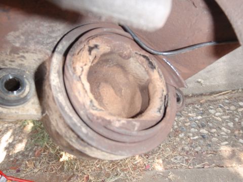 1994 Ford Bronco - Close-up of a corroded balljoint housing, showing wear and tear.