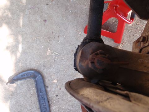1994 Ford Bronco - Ball joint assembly with a C-clamp tool and jack stand visible.