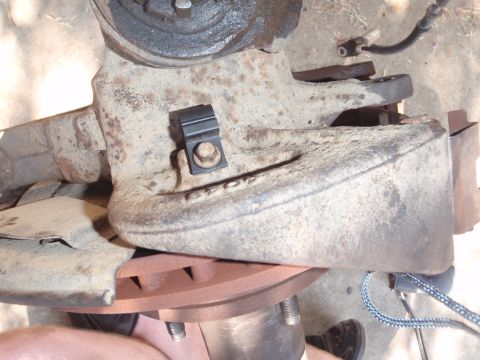 1994 Ford Bronco - Close-up view of a vehicle's balljoint assembly, including the brake rotor and a sensor wire.