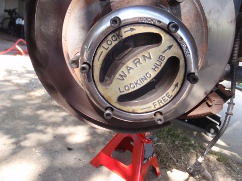 1994 Ford Bronco - Close-up of a Warn Locking Hub, indicating its function for a vehicle's wheel.