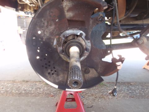 1994 Ford Bronco - Close-up of a corroded front wheel hub assembly, indicating a need for repair or replacement.