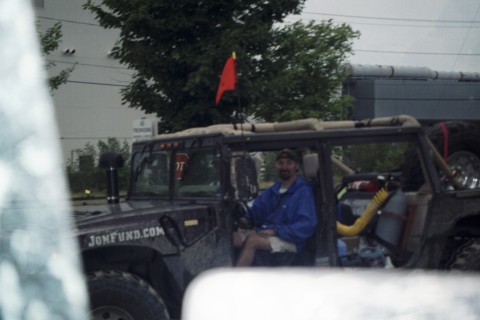 1979 Ford Bronco II - An off-road vehicle, possibly modified, is seen with a red flag and a driver inside.