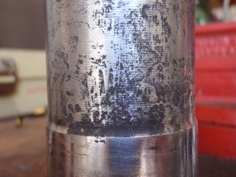 1994 Ford Bronco - This metal cylinder shows significant wear and damage.