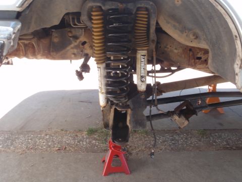 1994 Ford Bronco - Vehicle front suspension components, including Superlift shocks, are shown while supported by jack stands.