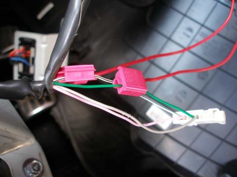 2010 Hyundai Genesis - This photo shows a close-up view of a vehicle's electrical wiring harness with multiple colored wires and connectors.