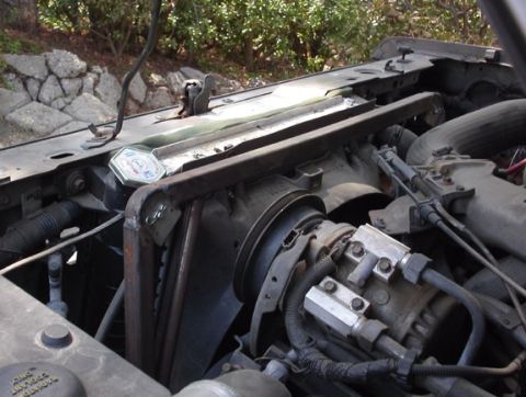 1990 Ford Bronco II - Framework housing a droop limiter cable for the front suspension. It lessens the amount the hood rises up on steep climbs due to weight tra…