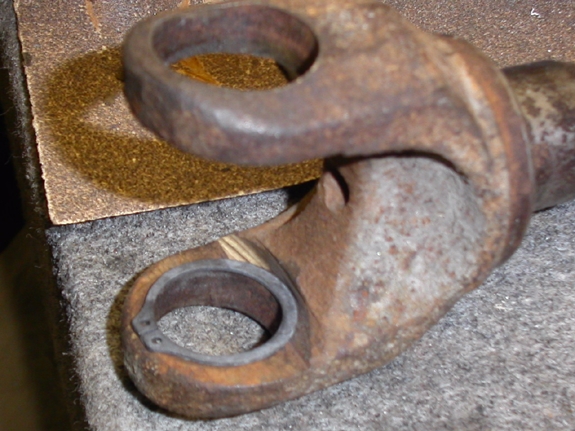 Axle yoke modified to accept a full-circle snap ring clip (prevents spitting of the clips, leading to broken parts)