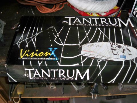1985 Ford Bronco - The box displays a spider web graphic and branding for a Tantrum Professional L.E.D. Strobe System.