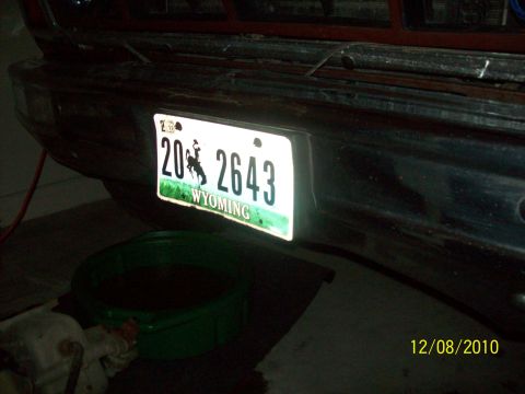 1985 Ford Bronco - A Wyoming license plate is mounted on the rear bumper of a vehicle, with a drain pan below.
