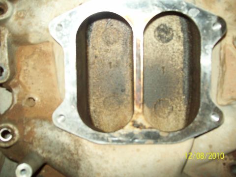 1985 Ford Bronco - Close-up view of intake manifold ports, showing significant carbon deposits.