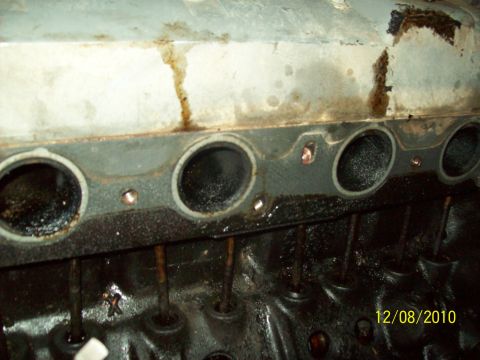 1985 Ford Bronco - Close-up view of an engine's cylinder head, showing exhaust ports and valve stems.