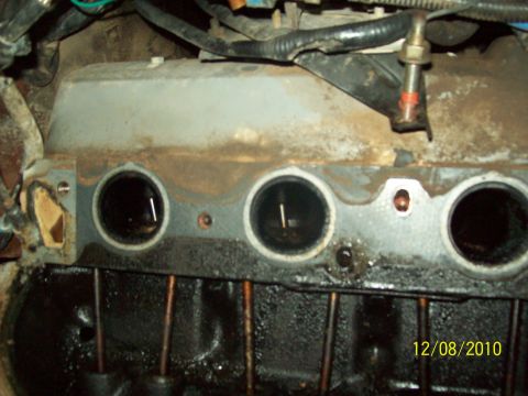 1985 Ford Bronco - Close-up view of an engine's cylinder head, showing ports and signs of oil.