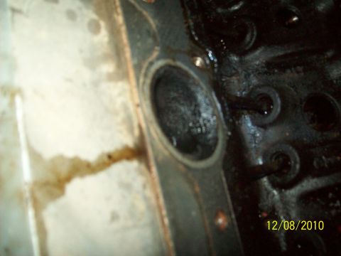 1985 Ford Bronco - Engine cylinder head gasket area showing oil residue and bolt holes.